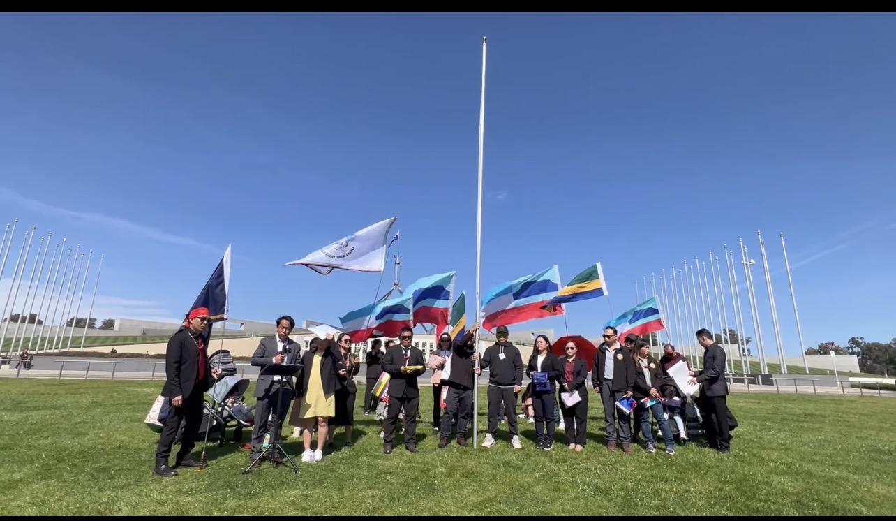 Screenshot of participants with flags at the Canberra historical flag ceremony